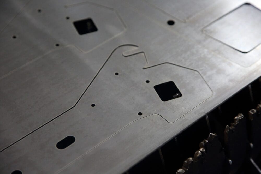 Laser-cut metal sheet with precise shapes and holes